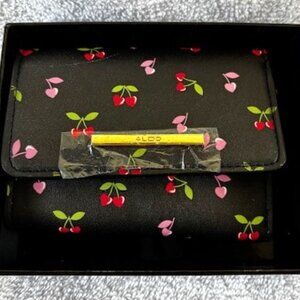 Aldo tri-fold wallet with cherries printed on black background.  NWT